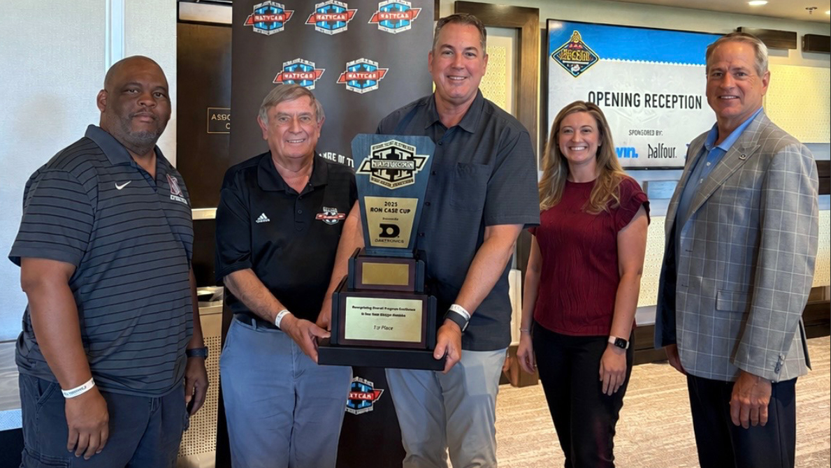 Mt. SAC Director of Athletics Joe Jennum holds Ron Case Cup trophy.