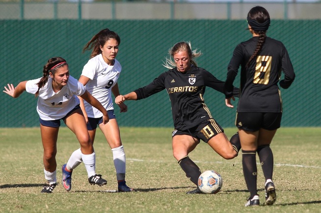 State scoring leader and Cerritos' Sydney Carr (with ball) in action.